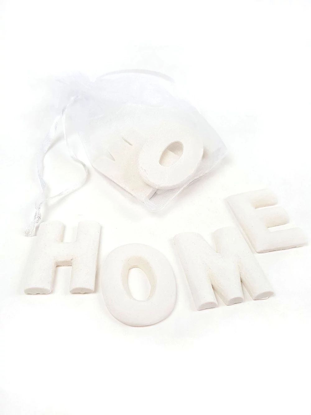 Polyresin betűk zsákban - HOME